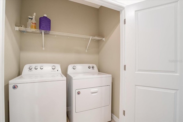 washroom featuring washer and dryer and laundry area