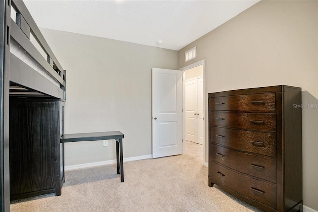 bedroom with light carpet and baseboards