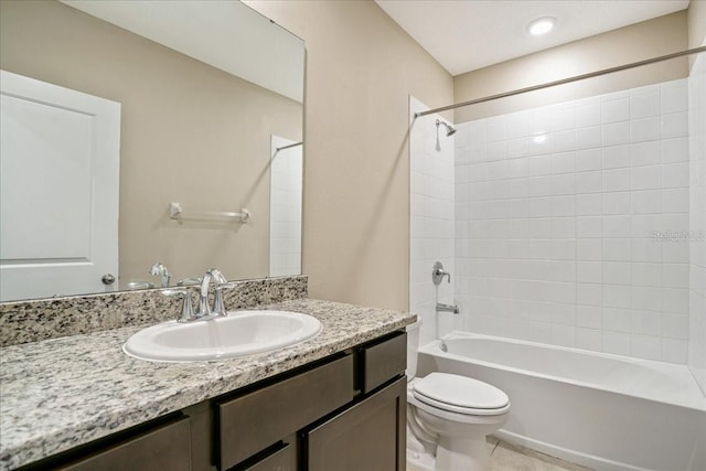 bathroom featuring toilet, tile patterned flooring, vanity, and shower / bathing tub combination