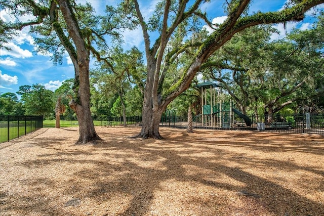 view of yard featuring fence and playground community