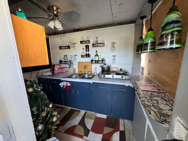 kitchen with ceiling fan, sink, and blue cabinetry