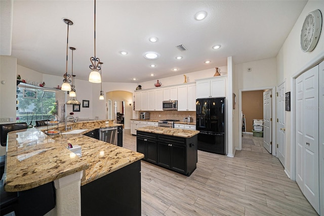 kitchen featuring white cabinetry, a spacious island, backsplash, stainless steel appliances, and hanging light fixtures