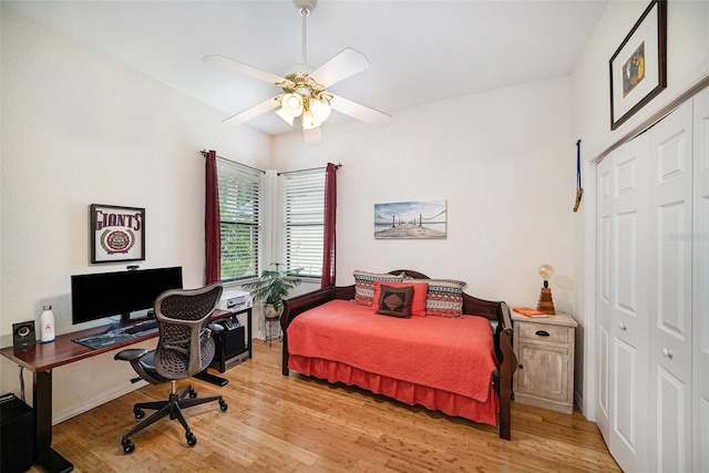 bedroom featuring ceiling fan, a closet, and light hardwood / wood-style floors