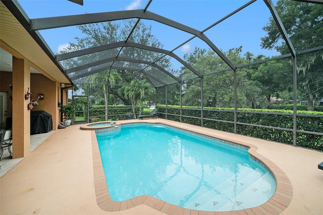 view of swimming pool featuring a lanai, a patio area, and an in ground hot tub