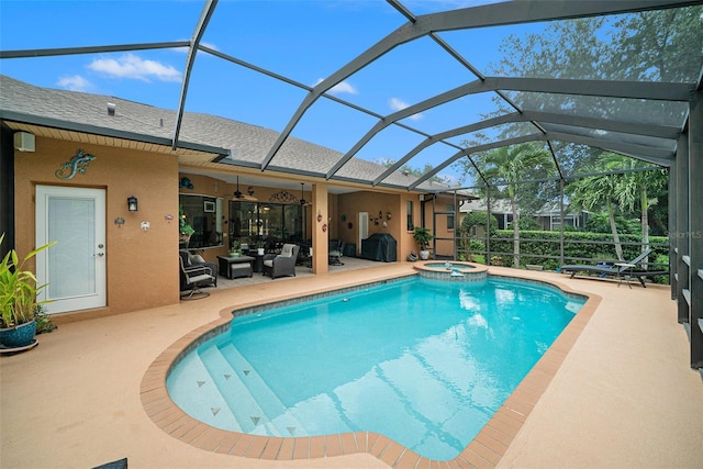 view of swimming pool featuring a lanai, a patio area, and an in ground hot tub