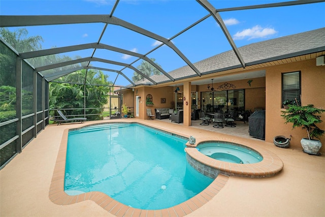 view of pool featuring an in ground hot tub, a patio, outdoor lounge area, glass enclosure, and ceiling fan