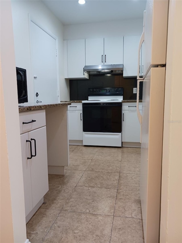 4606 W Gray St Unit 110, Tampa, FL 33609 - kitchen featuring range with electric cooktop, under cabinet range hood, white cabinets, freestanding refrigerator, and recessed lighting