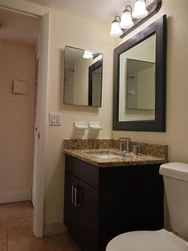4606 W Gray St Unit 110, Tampa, FL 33609 - bathroom with toilet, tile patterned flooring, and vanity