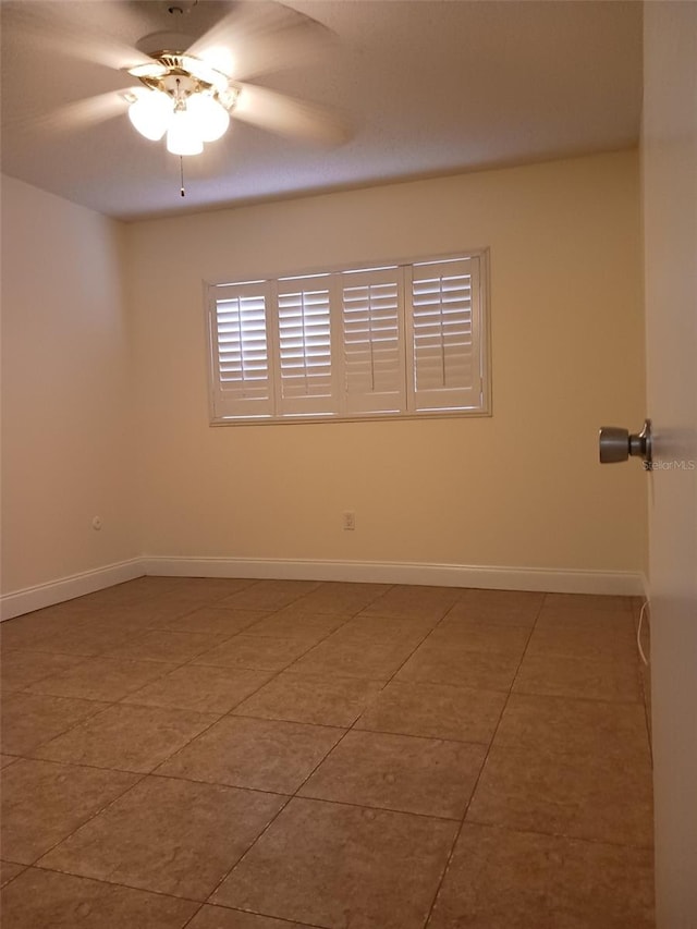 tiled empty room with ceiling fan