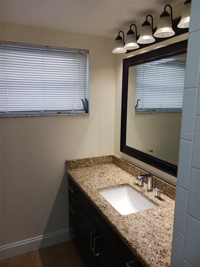 4606 W Gray St Unit 110, Tampa, FL 33609 - bathroom with vanity, baseboards, and tile patterned flooring