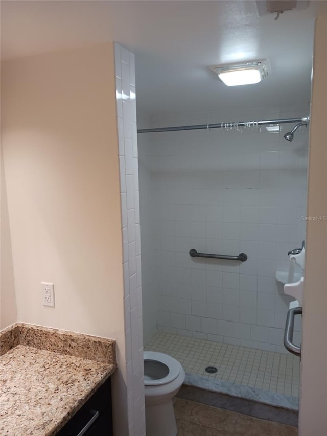 4606 W Gray St Unit 110, Tampa, FL 33609 - bathroom with a shower stall, vanity, toilet, and tile patterned floors