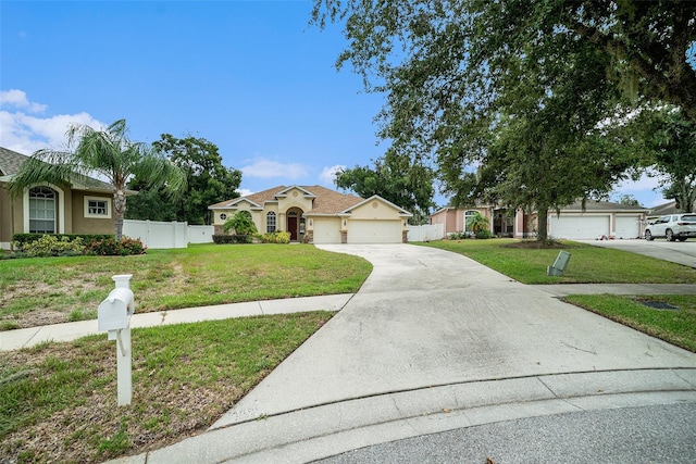 ranch-style house featuring a front yard and a garage