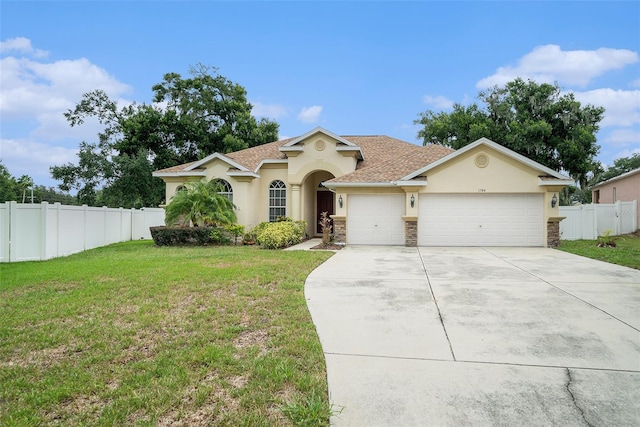 view of front of house with a garage and a front yard