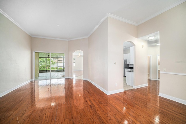 unfurnished room featuring ornamental molding and hardwood / wood-style floors