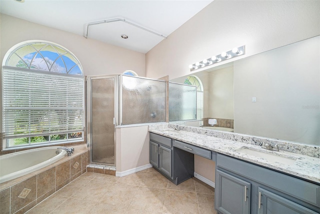 bathroom with plus walk in shower, tile patterned flooring, and vanity