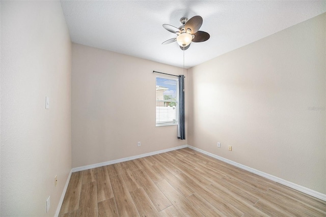 spare room with ceiling fan and light wood-type flooring