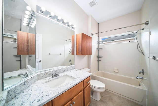 full bathroom with vanity, toilet, tile patterned floors, and tiled shower / bath