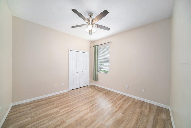 empty room featuring ceiling fan and light hardwood / wood-style flooring