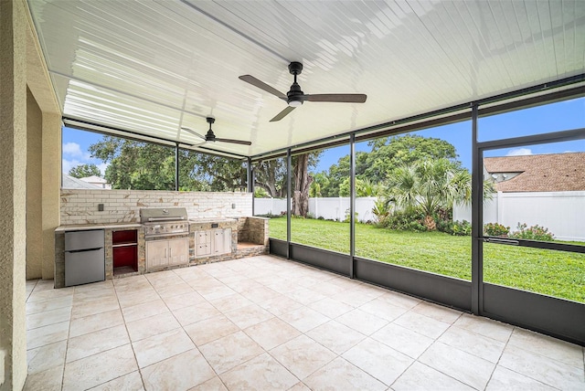 unfurnished sunroom with ceiling fan