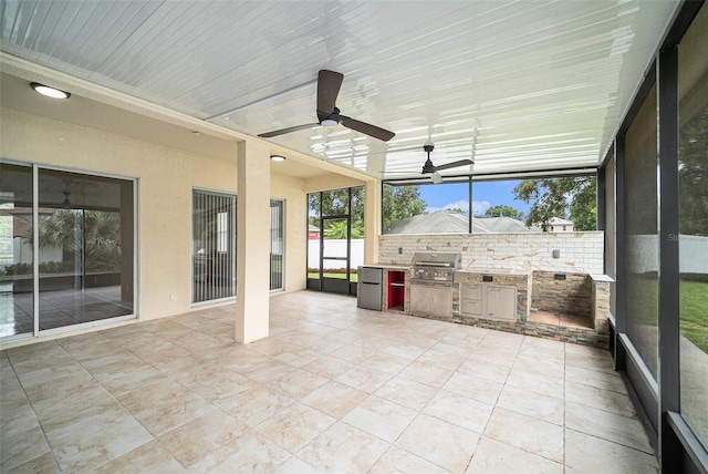 unfurnished sunroom with ceiling fan