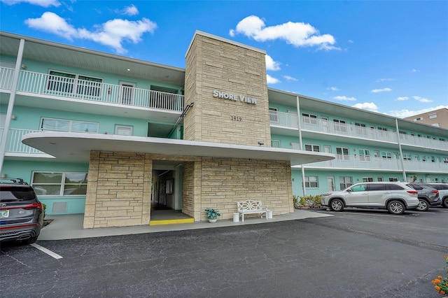 view of property with uncovered parking