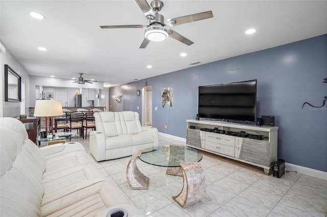 living room with ceiling fan and light tile patterned floors