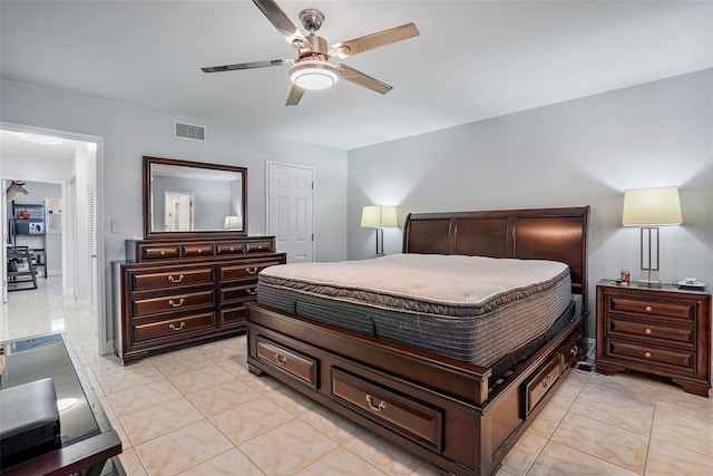 tiled bedroom featuring ceiling fan