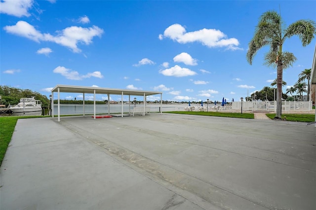 1819 Shore Dr S Unit 318, South Pasadena, FL 33707 - view of parking / parking lot featuring fence, concrete driveway, and a detached carport