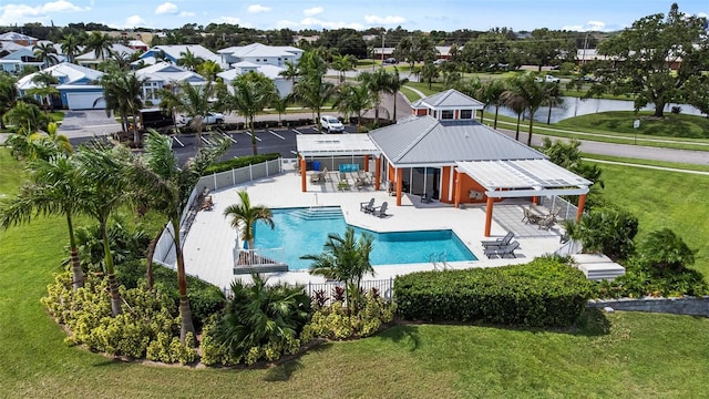 view of pool with a lawn, a patio, and a water view