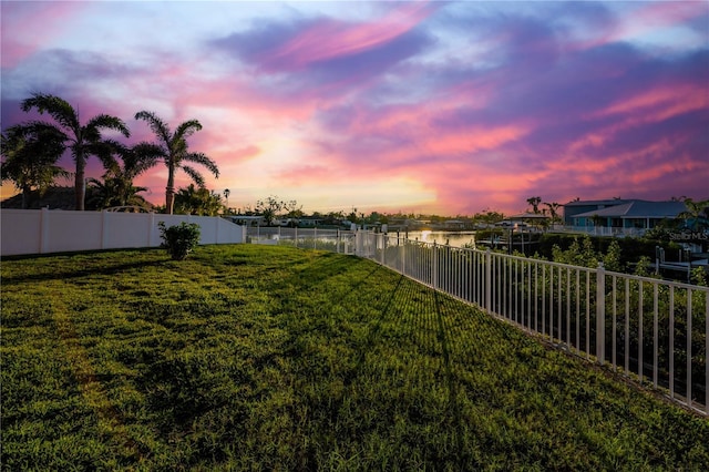 yard at dusk with a water view