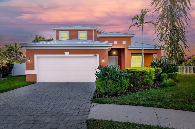 view of front of property featuring a lawn and a garage