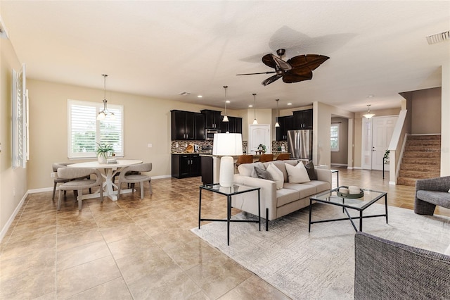 living room with light tile patterned flooring and ceiling fan