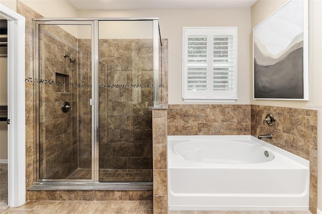 bathroom featuring separate shower and tub