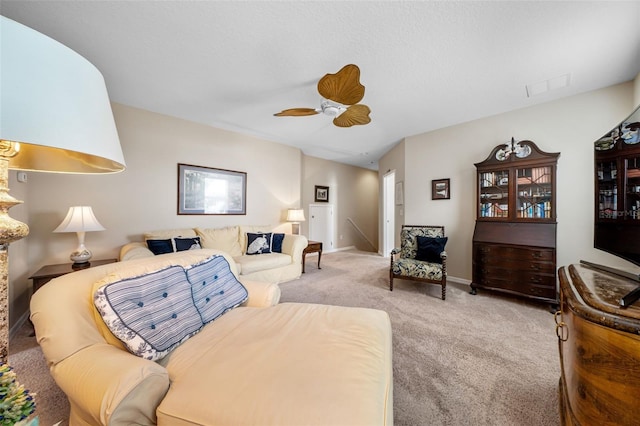 carpeted living room with ceiling fan