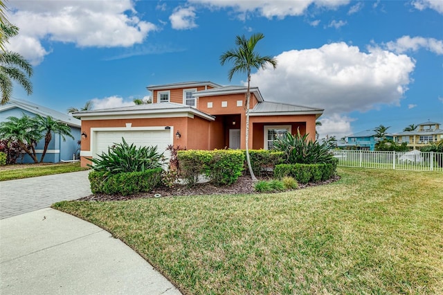 view of front of home featuring a garage and a front lawn