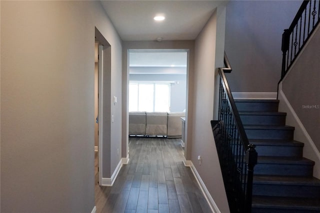 staircase with recessed lighting, baseboards, and wood finished floors