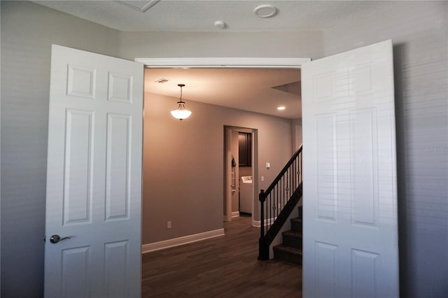 stairs featuring visible vents, wood finished floors, and baseboards