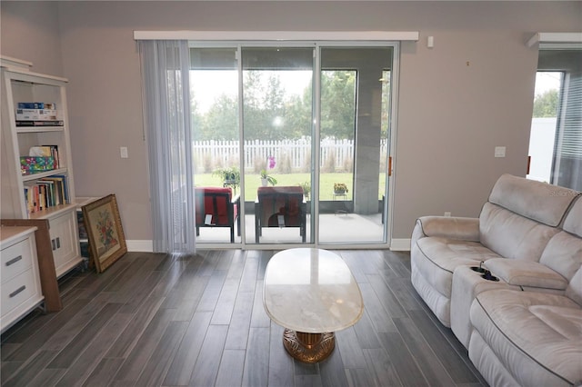 living area with dark wood finished floors and baseboards