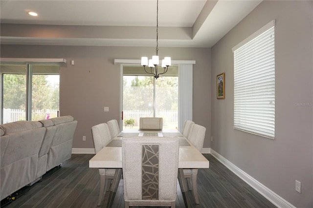 dining space with dark wood-style floors, baseboards, a wealth of natural light, and a chandelier