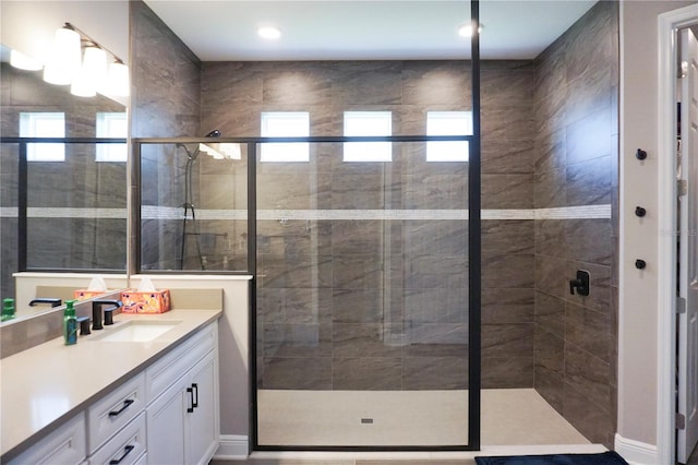 bathroom featuring a wealth of natural light, a stall shower, and vanity