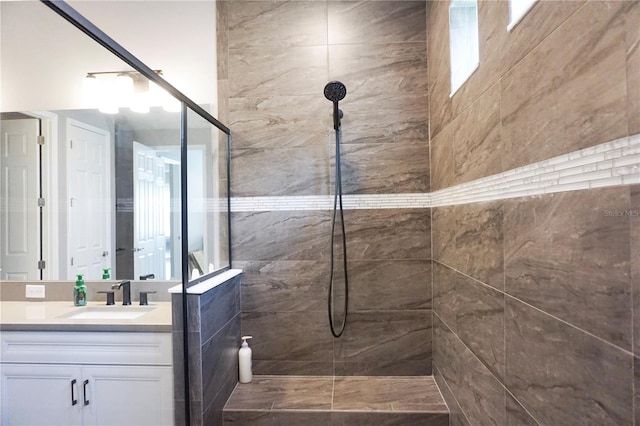 full bathroom with vanity and a tile shower