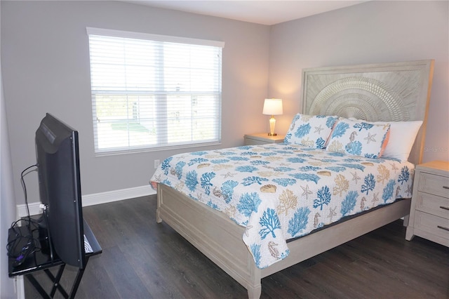 bedroom featuring baseboards and dark wood-style flooring