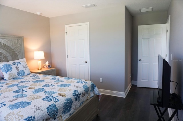 bedroom with visible vents, baseboards, and dark wood-style flooring