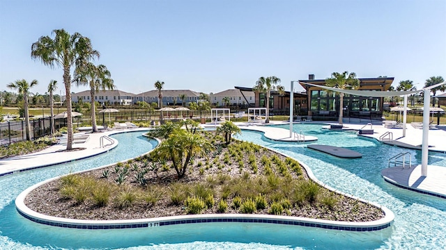 view of home's community with a swimming pool, a patio, and fence