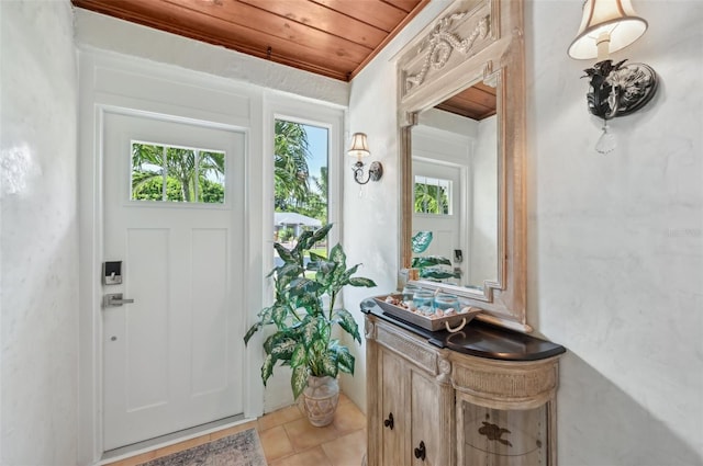 tiled entryway featuring wood ceiling