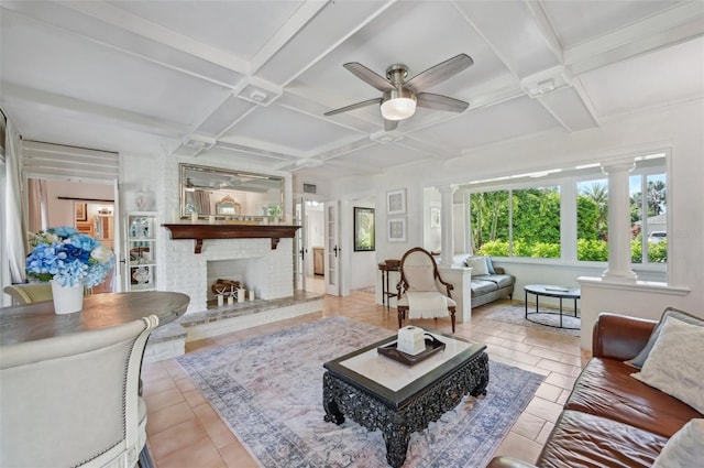 sunroom / solarium with a brick fireplace, coffered ceiling, decorative columns, and a ceiling fan