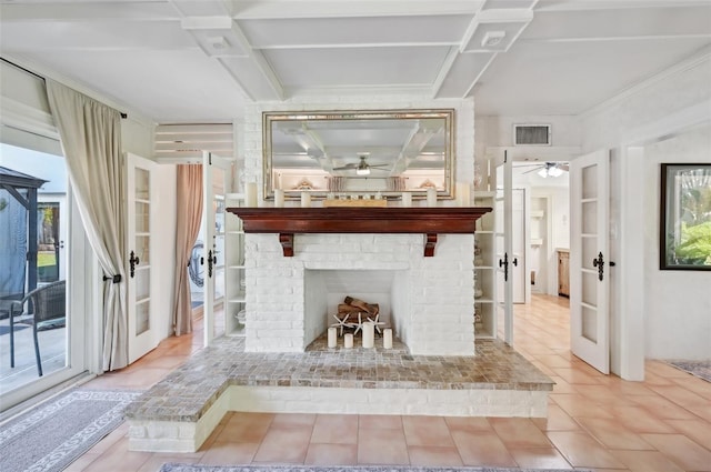 interior space featuring a fireplace, visible vents, a ceiling fan, and french doors