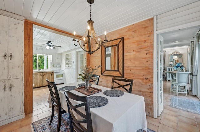 dining space featuring wood ceiling, wooden walls, ceiling fan with notable chandelier, and light tile patterned flooring