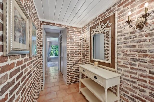 hall with wooden ceiling, brick wall, and light tile patterned floors