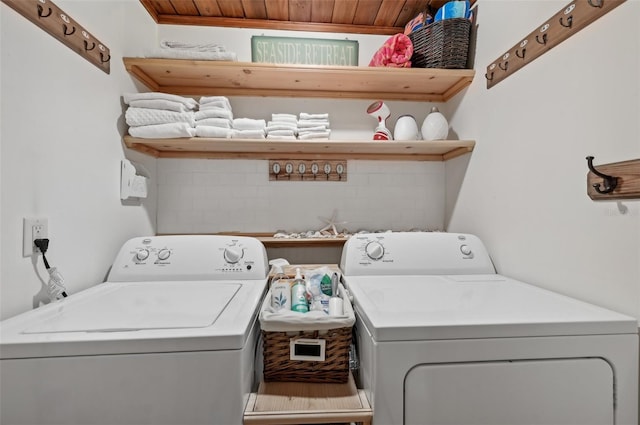 laundry room with laundry area, washer and clothes dryer, and wood ceiling